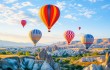 Colorful,Hot,Air,Balloons,Flying,Over,Rock,Landscape,At,Cappadocia