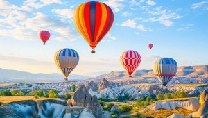 Colorful,Hot,Air,Balloons,Flying,Over,Rock,Landscape,At,Cappadocia